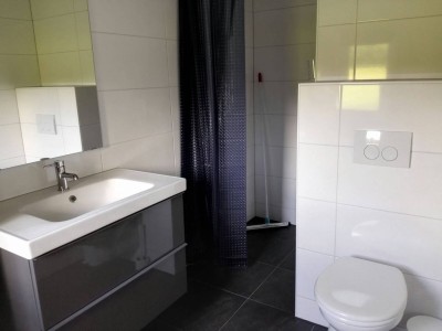 De badkamer met WC en douche